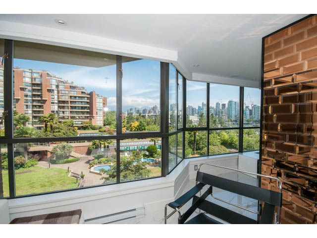 Bright living room with large windows, city view, and modern decor. - 307 - 1490 Pennyfarthing Drive, Vancouver West Side