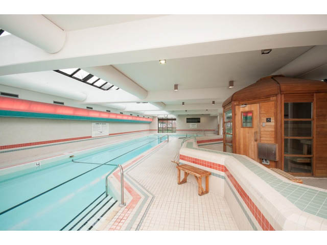 Spacious, modern 2-bedroom condo with large windows, hardwood floors, and a cozy living area. - 307 - 1490 Pennyfarthing Drive, Vancouver West Side