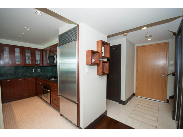 Bright kitchen with dark wood cabinets, stainless steel appliances, and tiled flooring. - 803 - 590 Nicola Street, Vancouver Downtown