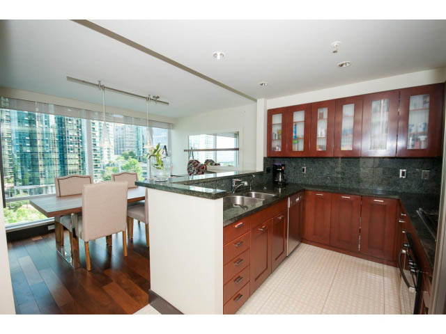 Bright kitchen with dark granite countertops, hardwood floors, and city view. - 803 - 590 Nicola Street, Vancouver Downtown