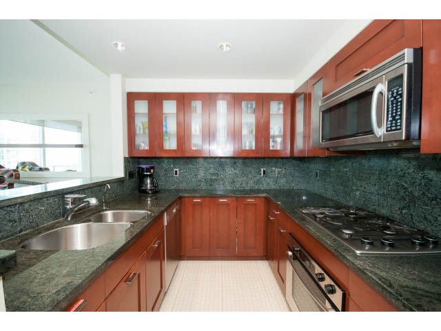 Bright kitchen with dark green countertops, stainless steel appliances, and wooden cabinets. - 803 - 590 Nicola Street, Vancouver Downtown