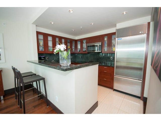Bright kitchen with dark green countertops, hardwood floors, and stainless steel appliances. - 803 - 590 Nicola Street, Vancouver Downtown