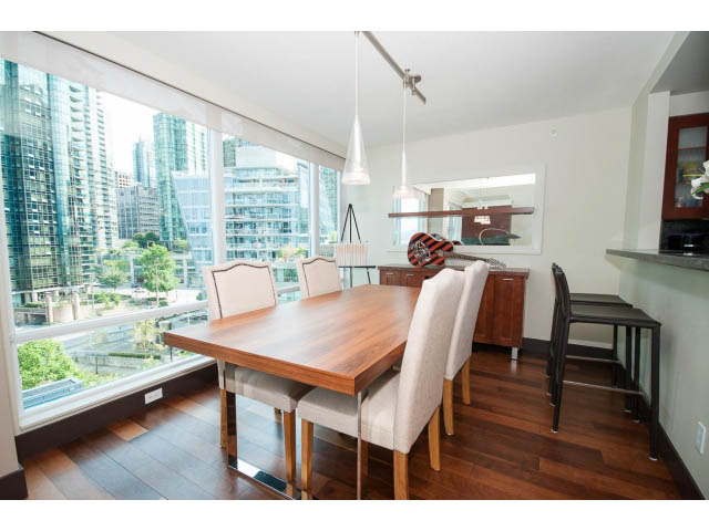 Bright dining area with city view, hardwood floors, and modern decor. - 803 - 590 Nicola Street, Vancouver Downtown