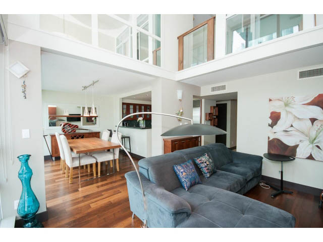 Bright loft living room with hardwood floors, modern furniture, and a large window view. - 803 - 590 Nicola Street, Vancouver Downtown