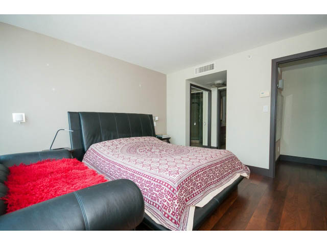 Furnished living space with red accents, hardwood floors, and a mirrored wall. - 803 - 590 Nicola Street, Vancouver Downtown