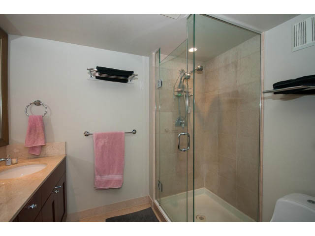 Bright bathroom with glass shower, pink towels, and beige countertop. - 803 - 590 Nicola Street, Vancouver Downtown
