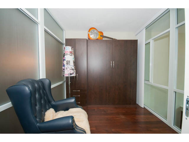 Furnished living room with dark wood cabinets and a cozy armchair. - 803 - 590 Nicola Street, Vancouver Downtown