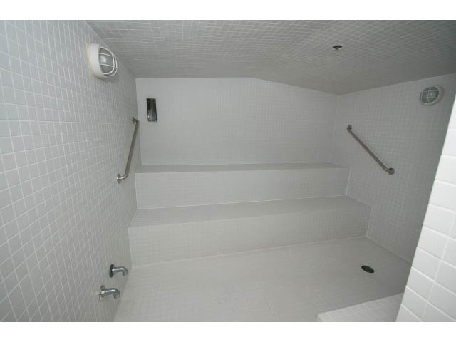 Bathroom with tiled walls and floor, grab bars for accessibility. - 803 - 590 Nicola Street, Vancouver Downtown