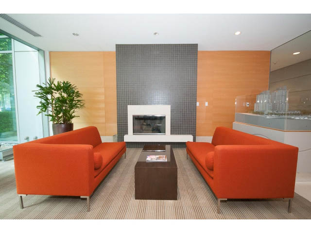 Bright living room with orange furniture and modern decor, featuring a city view through large windows. - 803 - 590 Nicola Street, Vancouver Downtown