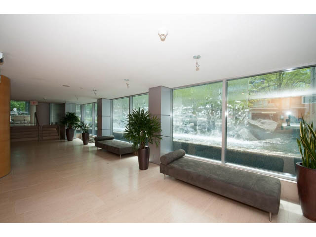 Furnished living room with hardwood floors, large windows, and city view. - 803 - 590 Nicola Street, Vancouver Downtown