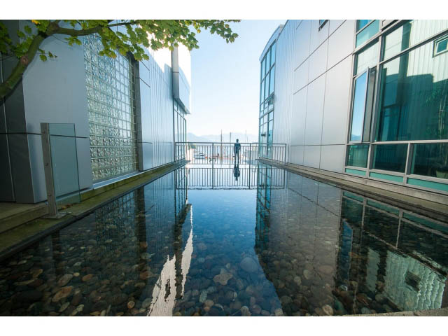 Loft with water feature and modern glass facade, reflecting city skyline. - 803 - 590 Nicola Street, Vancouver Downtown