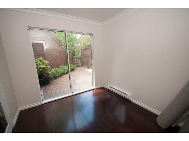 Furnished den with hardwood floors and sliding glass door leading to outdoor patio. - 1122 Ironwork Passage, Vancouver West Side
