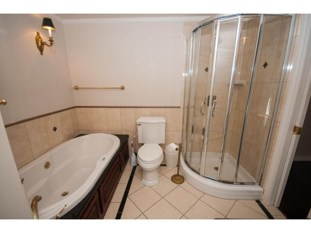 Furnished bathroom with a corner shower and a freestanding bathtub. - 1122 Ironwork Passage, Vancouver West Side