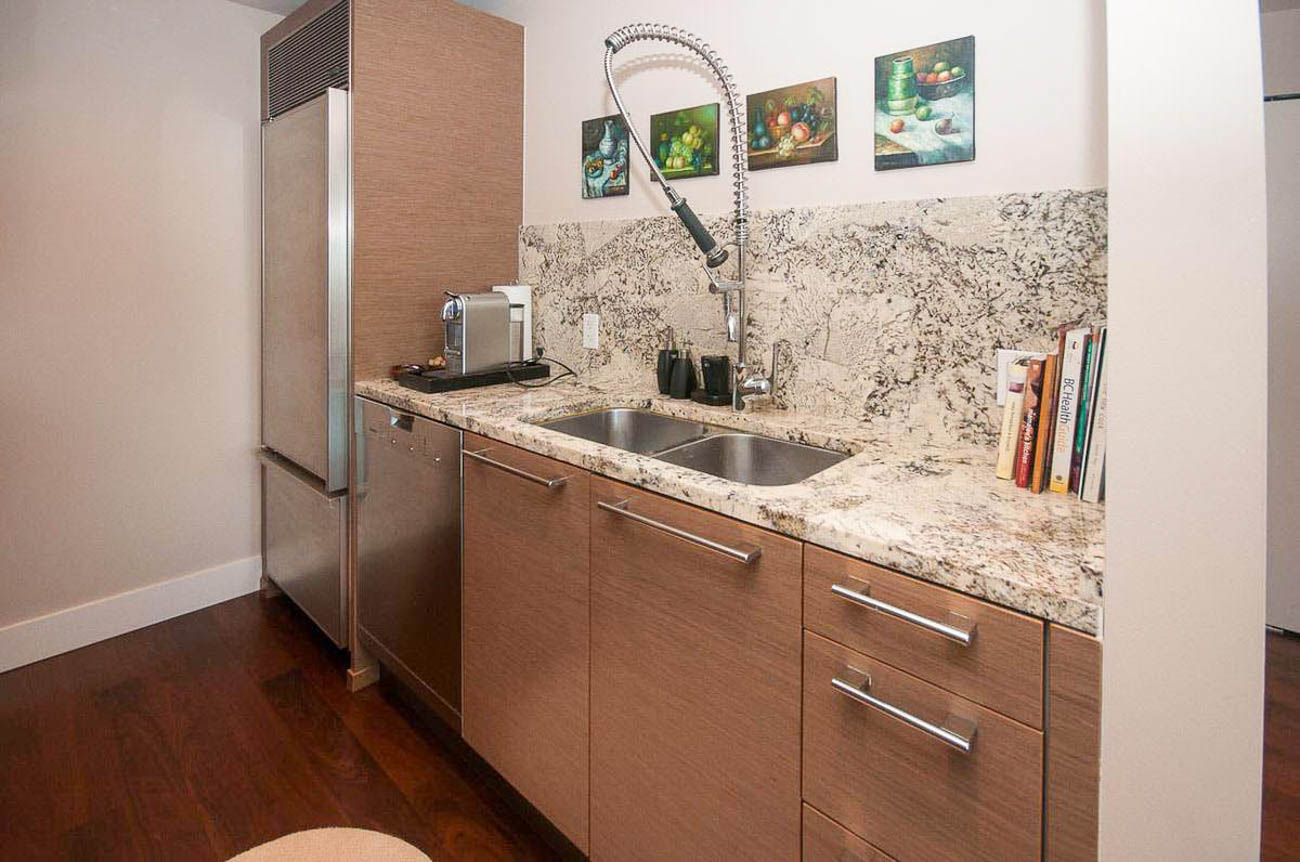 Bright kitchen with granite countertops, hardwood floors, and a modern faucet. - 2806 - 1111 Alberni Street, Vancouver Downtown