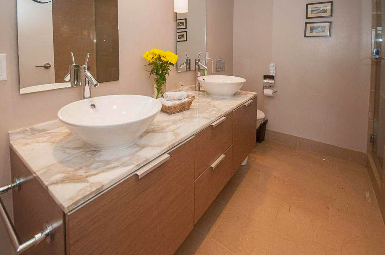 Furnished bathroom with marble countertop and modern sink, hardwood floors. - 2806 - 1111 Alberni Street, Vancouver Downtown
