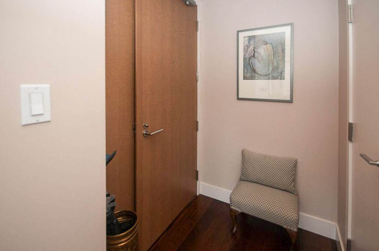Foyer with wooden doors, light switch, and framed artwork. - 2806 - 1111 Alberni Street, Vancouver Downtown