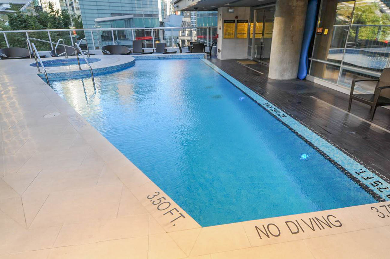 Spacious rooftop pool with city views and tiled deck. - 2806 - 1111 Alberni Street, Vancouver Downtown
