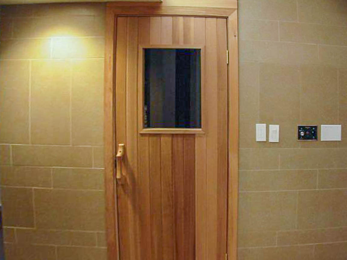 Furnished bedroom with wooden door and window, beige walls. - 2806 - 1111 Alberni Street, Vancouver Downtown