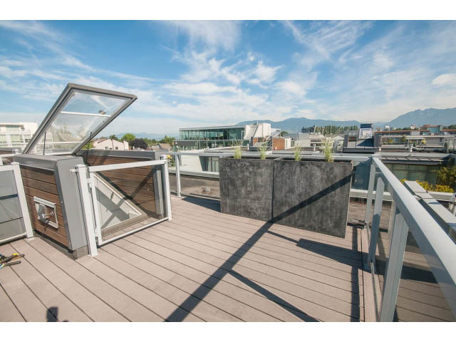Bright rooftop deck with wooden flooring and city view. - 204 - 1750 West 3rd Avenue, Vancouver West Side