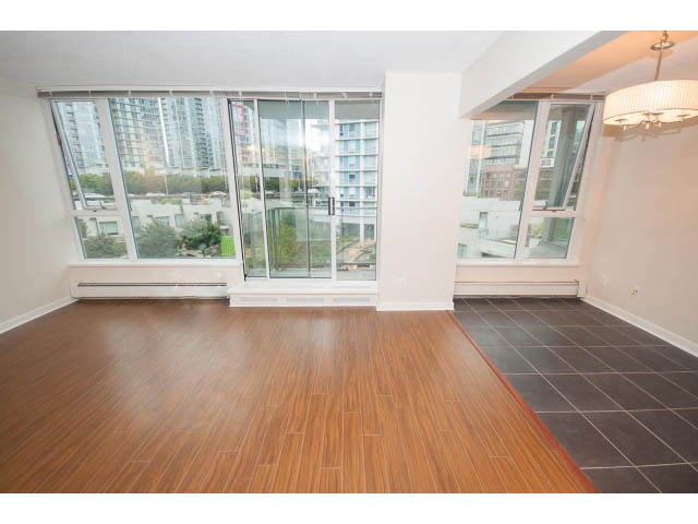 Bright living room with hardwood floors, city view, and modern decor. - 605 - 633 Abbott St, Vancouver Downtown
