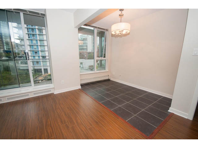 Bright living room with hardwood floors and city view. - 605 - 633 Abbott St, Vancouver Downtown