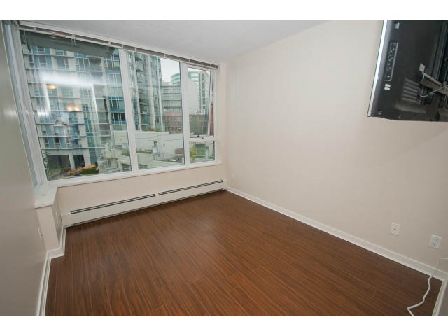 Bright living room with hardwood floors and city view. - 605 - 633 Abbott St, Vancouver Downtown
