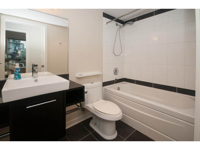 Furnished bathroom with black and white tiles, modern sink, and shower. - 605 - 633 Abbott St, Vancouver Downtown