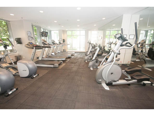Spacious gym with cardio equipment and large windows. - 605 - 633 Abbott St, Vancouver Downtown