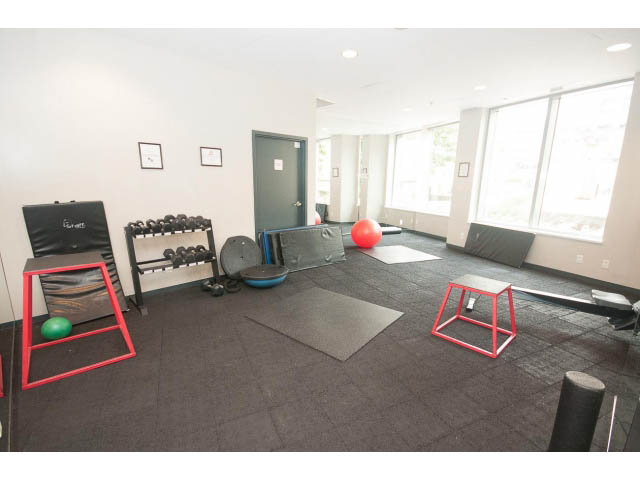 Bright and spacious fitness room with exercise mats, weights, and a pull-up bar. - 605 - 633 Abbott St, Vancouver Downtown