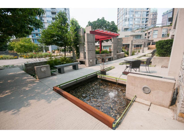 Furnished living room with modern decor, city view, and outdoor patio access. - 605 - 633 Abbott St, Vancouver Downtown