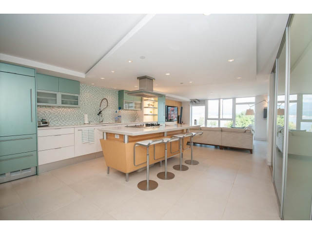 Bright kitchen with modern appliances, light wood cabinets, and a city view. - 708 - 27 Alexander St, Vancouver Downtown