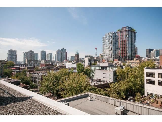 Bright rooftop patio with stunning city view and modern furnishings. - 708 - 27 Alexander St, Vancouver Downtown