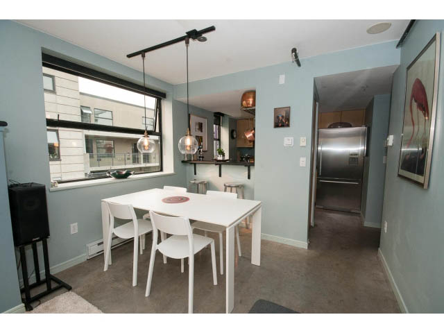 Bright kitchen with modern appliances, city view, and white dining area. - 716 - 428 West 8th Ave, Vancouver West Side