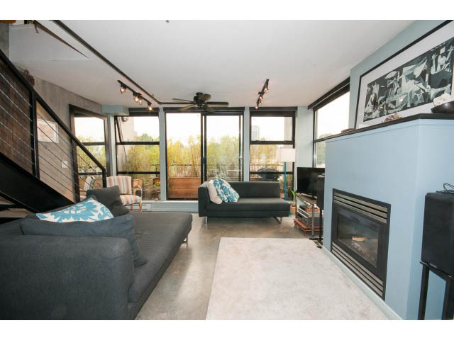 Bright living room with large windows, modern furniture, and a fireplace. - 716 - 428 West 8th Ave, Vancouver West Side