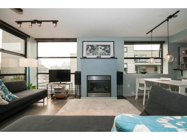 Furnished living room with modern decor, large windows, and city view. - 716 - 428 West 8th Ave, Vancouver West Side