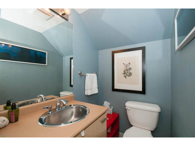 Furnished bathroom with light blue walls, red storage, and a modern sink. - 716 - 428 West 8th Ave, Vancouver West Side
