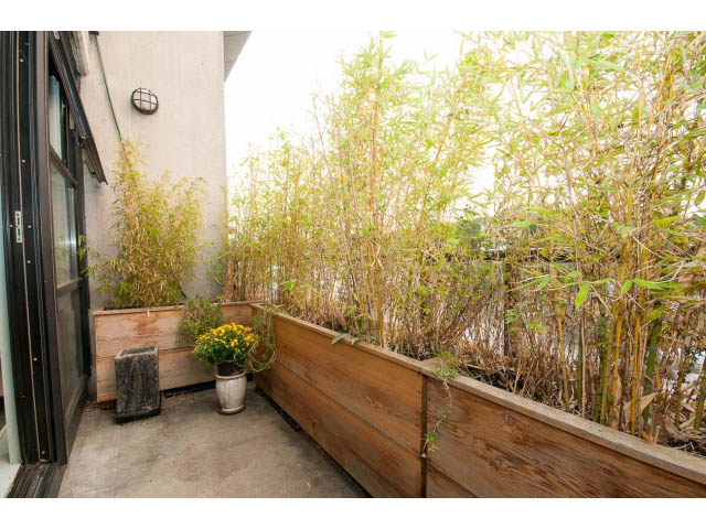 Furnished balcony with wooden planters and bamboo, offering a natural and cozy atmosphere. - 716 - 428 West 8th Ave, Vancouver West Side