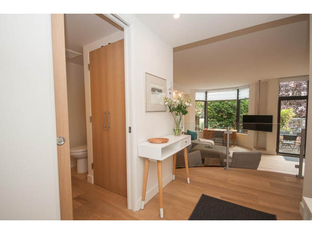 Bright living room with hardwood floors and city view. - 103 - 1860 Robson Street, Vancouver Downtown