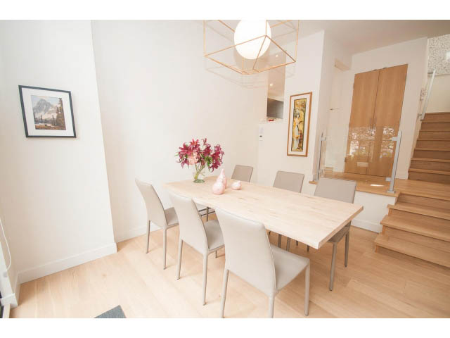 Bright dining area with modern chairs, light wood floors, and a geometric chandelier. - 103 - 1860 Robson Street, Vancouver Downtown