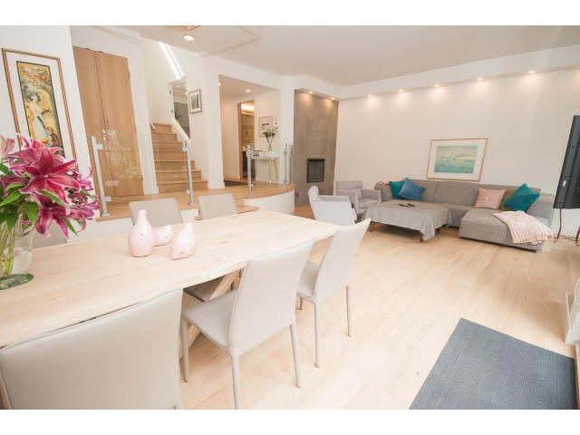 Furnished living room with hardwood floors and a cozy corner sofa. - 103 - 1860 Robson Street, Vancouver Downtown