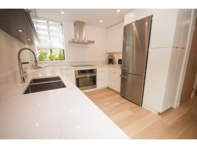 Bright kitchen with white countertops, stainless steel appliances, and hardwood floors. - 103 - 1860 Robson Street, Vancouver Downtown