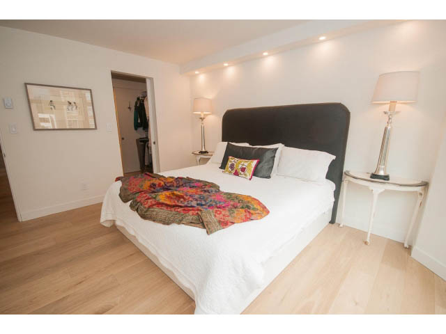 Bright bedroom with hardwood floors, cozy bedding, and a city view. - 103 - 1860 Robson Street, Vancouver Downtown