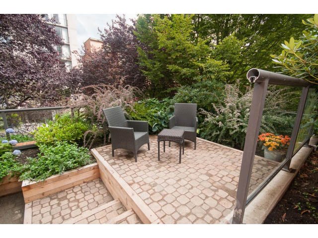 Furnished patio with stone flooring and greenery. - 103 - 1860 Robson Street, Vancouver Downtown