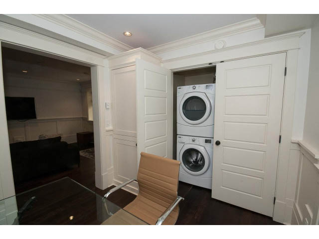 Laundry room with white cabinets and built-in washer/dryer. - 1836 Greer Ave, Vancouver West Side