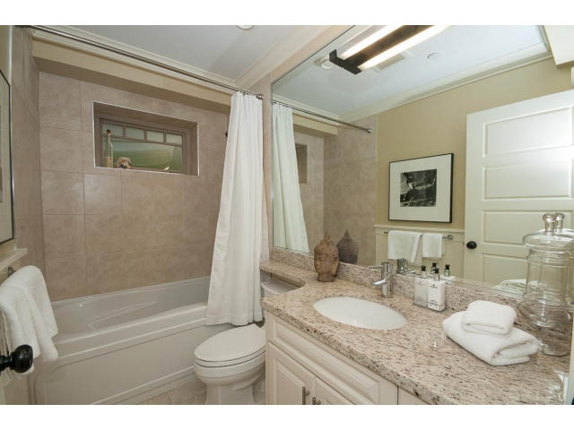 Bathroom with granite countertops and a large mirror. - 1836 Greer Ave, Vancouver West Side