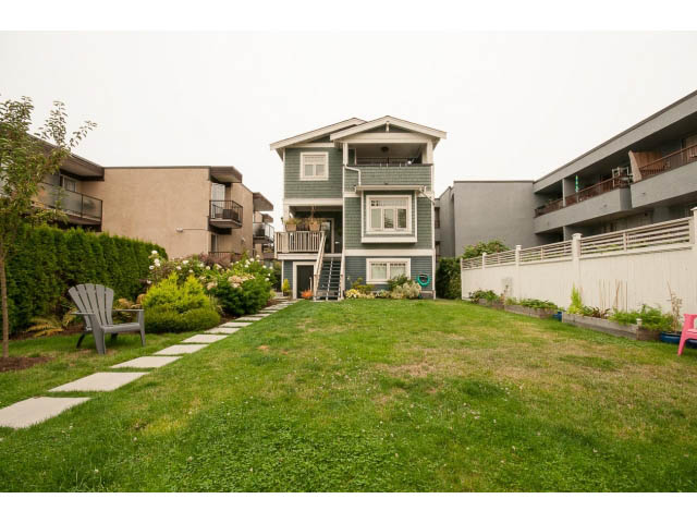 Furnished living room with cozy seating and greenery. - 1836 Greer Ave, Vancouver West Side