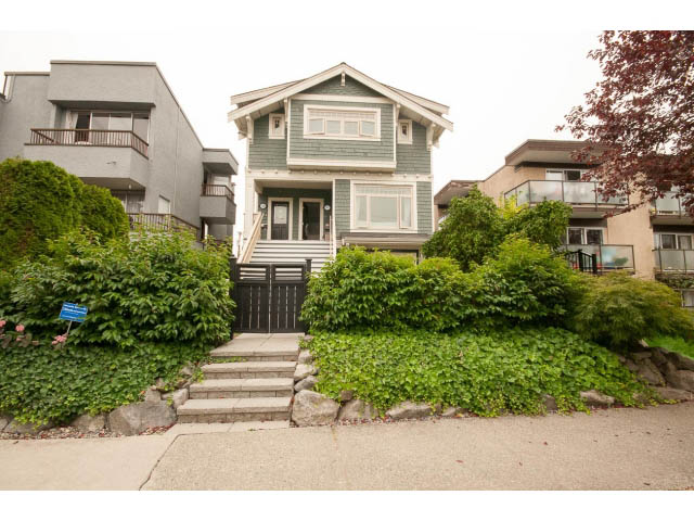 Furnished 2-bedroom triplex with ivy-covered exterior and steps leading up to the front door. - 1836 Greer Ave, Vancouver West Side