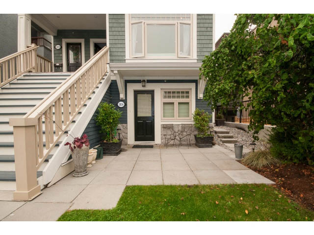 Furnished living area with stairs leading to upper levels, greenery surrounding. - 1836 Greer Ave, Vancouver West Side