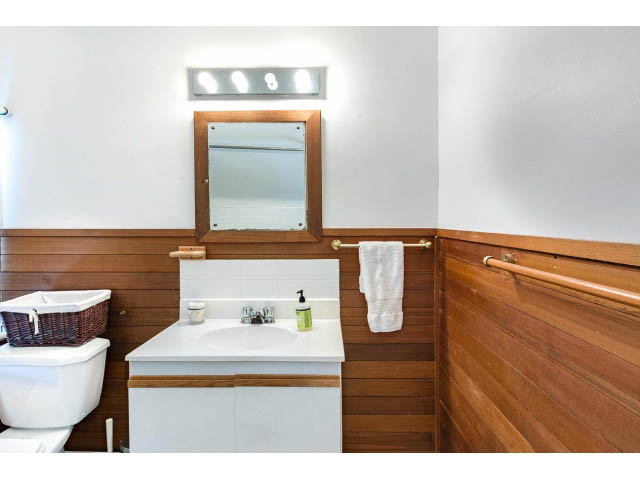 Bright bathroom with wooden accents and white fixtures. - Upper - 732 East 9th St, North Vancouver