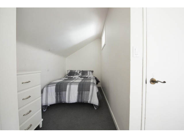 Bright bedroom with twin beds, white walls, and a closet. - Upper - 732 East 9th St, North Vancouver